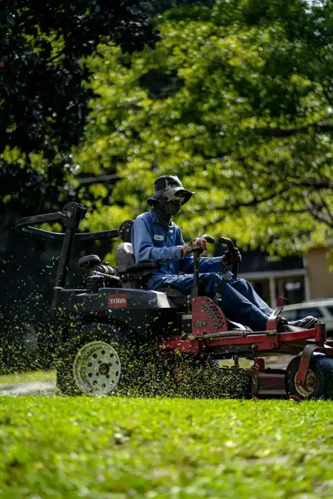 A Person Mowing the Lawn Grass